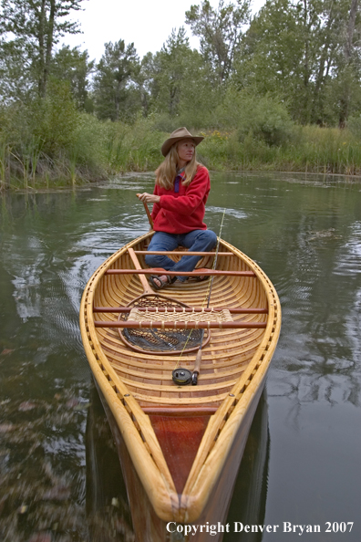 Woman canoeing on pond (MR).