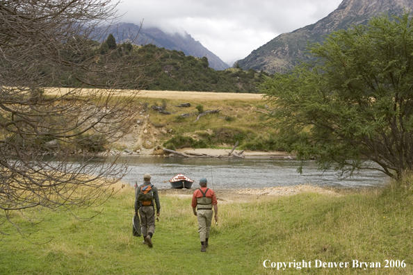 Flyfishermen walking to river.  Driftboat in background.