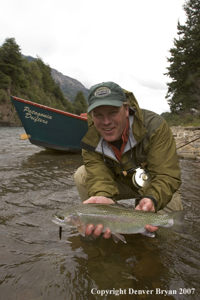 Flyfisherman holding nice rainbow trout.