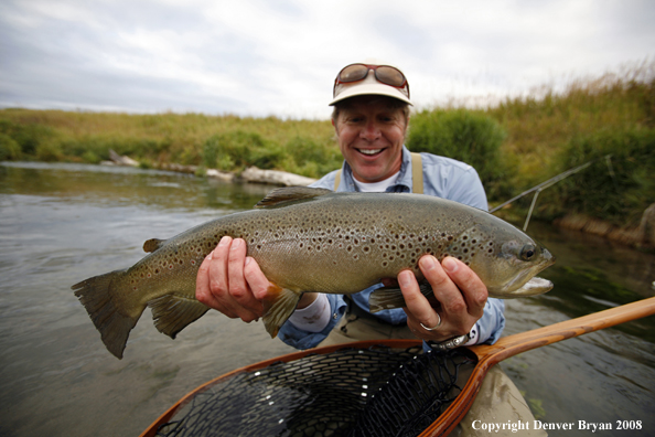 Flyfisherman with brown trout