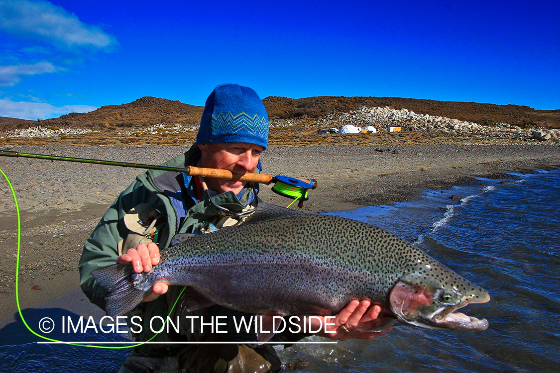 Jurassic Lake flyfisher with rainbow trout, Argentina.