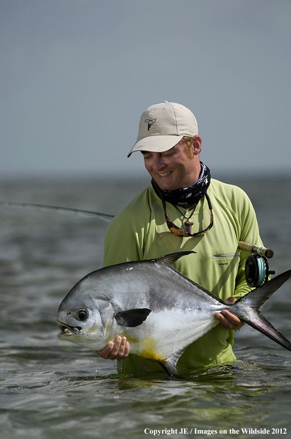 Flyfisherman holding permit catch.