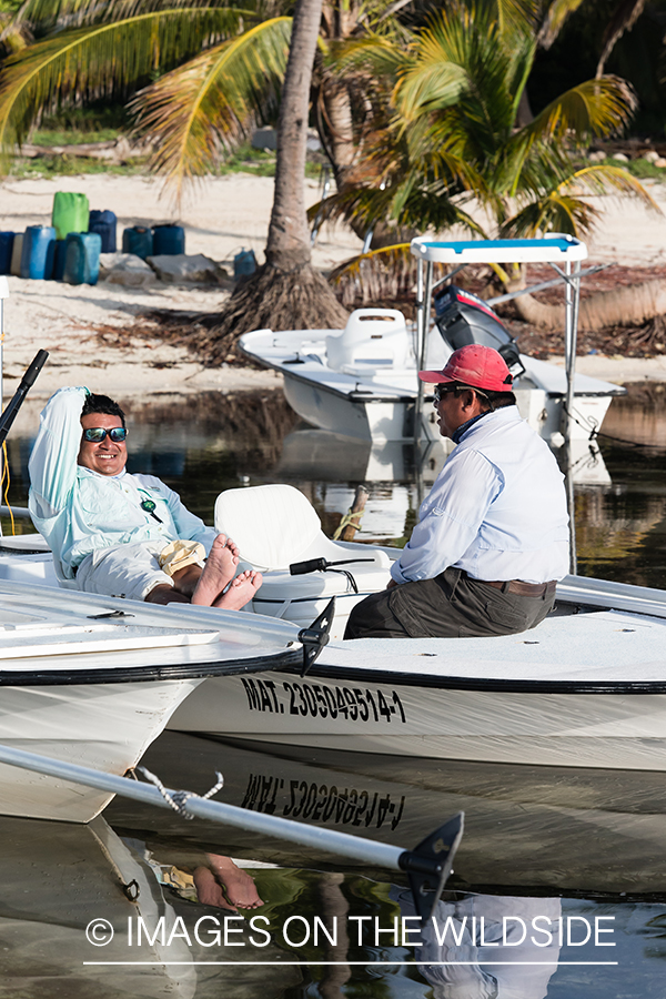 Flyfishermen relaxing on flats boats.