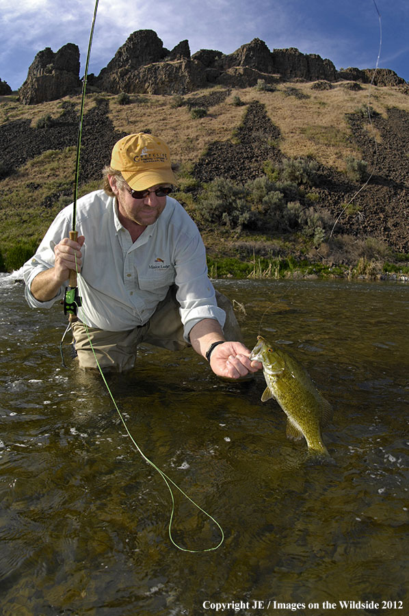 Fisherman with smallmouth bass.