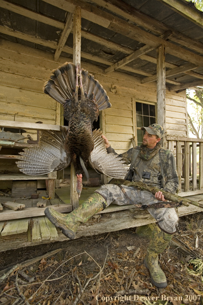 Turkey hunter in field with bagged bird