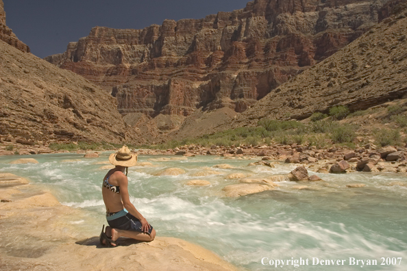 Woman sitting along side the Little Colorado River.  Grand Canyon.