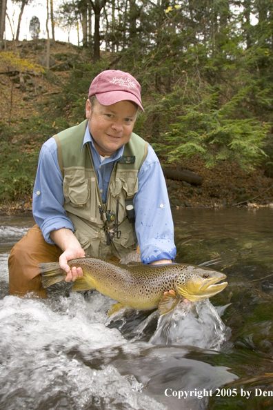 Flyfisherman with large brown trout.