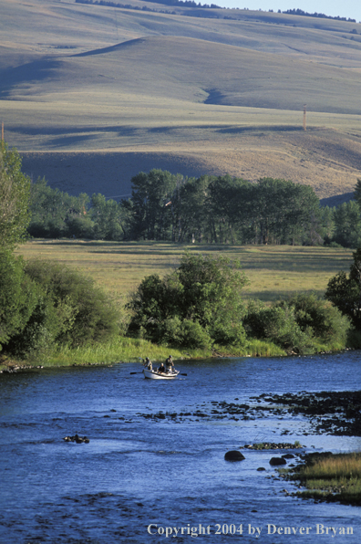 Fly fisherman casting from driftboat.