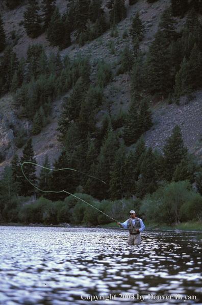 Flyfisherman casting on river.