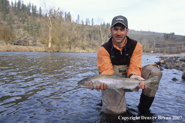 Flyfisherman holding steelhead.