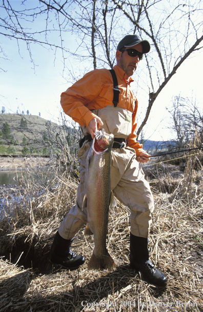 Flyfisherman with recently caught steelhead.