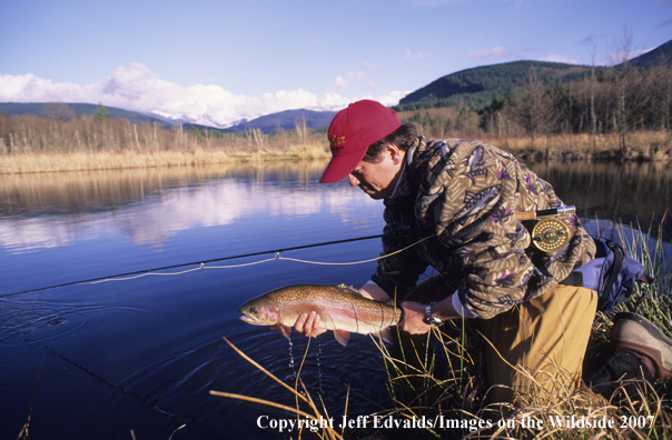 Flyfisherman with nice Rainbow Trout