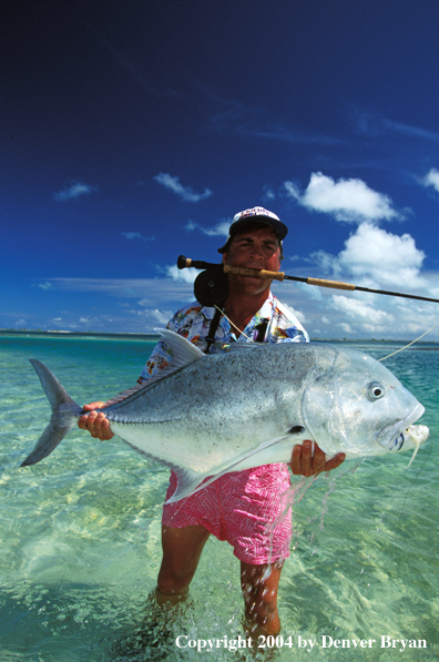 Saltwater flyfisherman holding trevally.