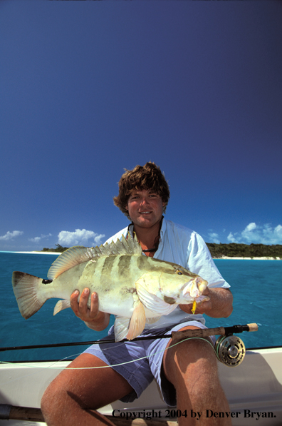 Saltwater flyfisherman holding a grouper.