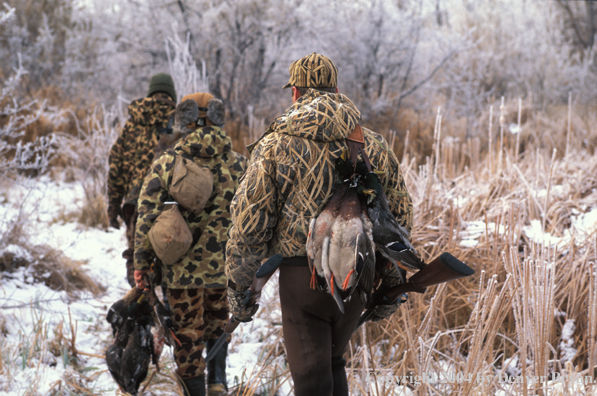 Waterfowl hunters with bagged fowl.