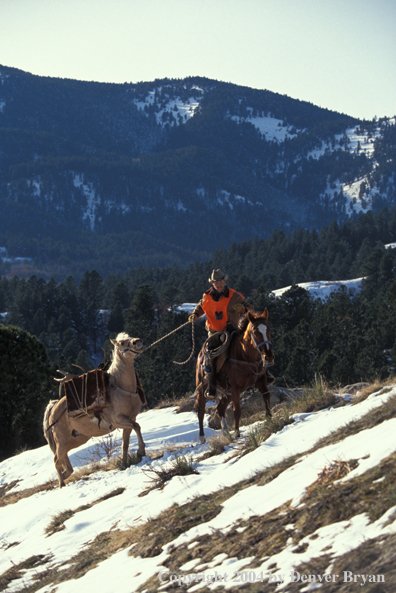 Successful big game hunter on horseback.