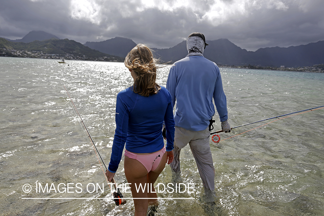 Woman flyfishing in saltwater with guide.