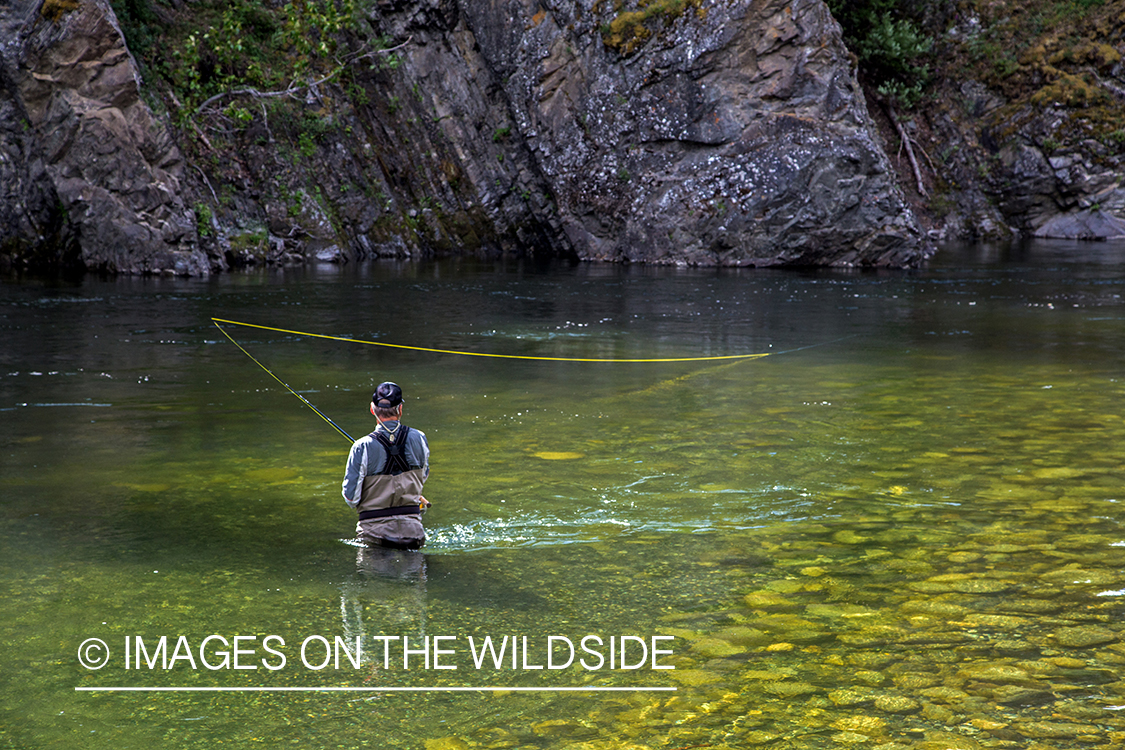 Flyfisherman spey casting on Nakina River, British Columbia.