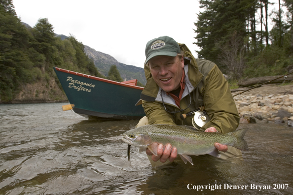 Flyfisherman holding nice rainbow trout.