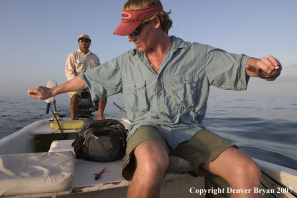 Saltwater flyfisherman stretching flyline