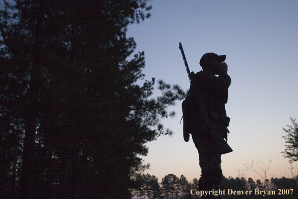 Turkey hunter calling in the field