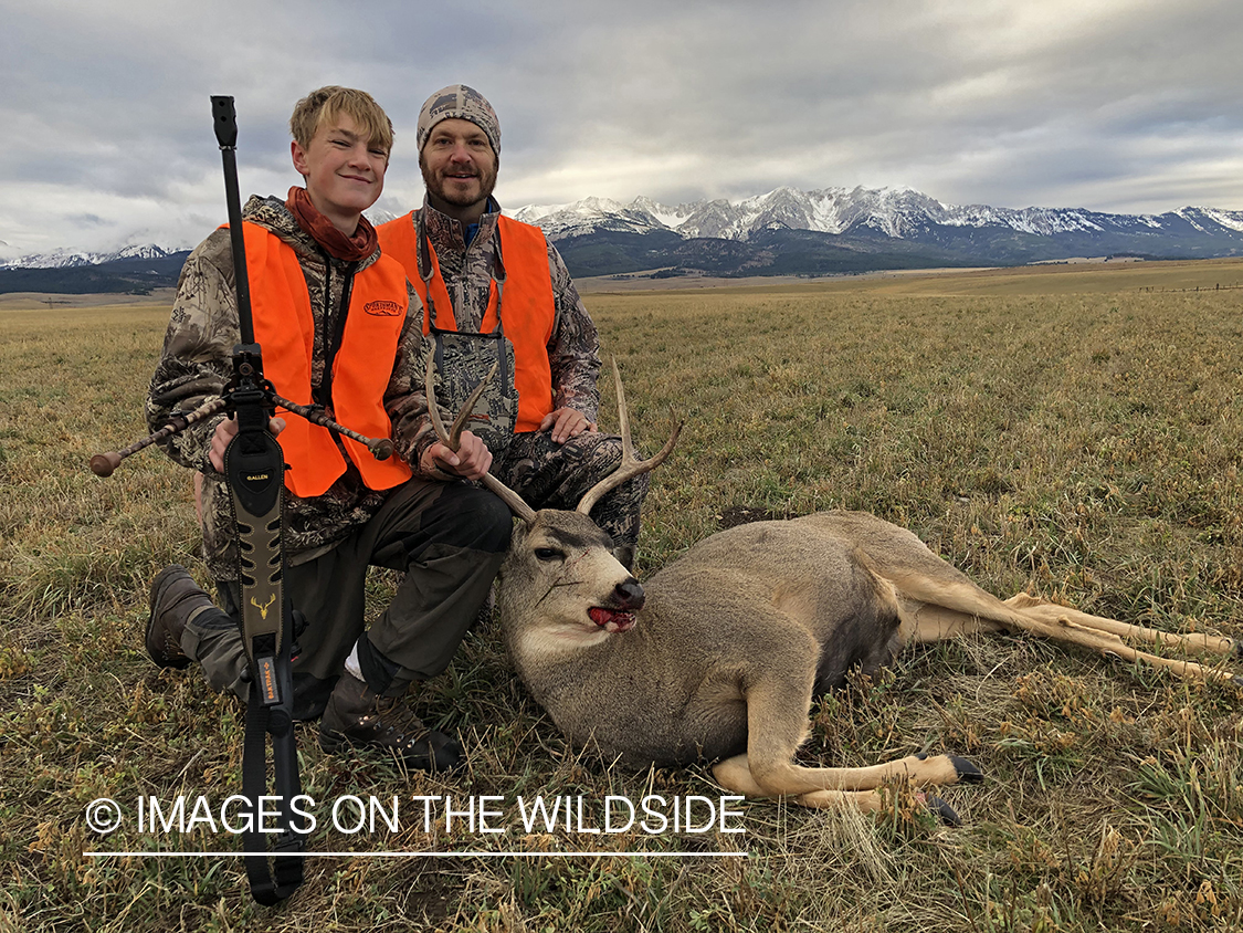 Father and son with downed mule deer.