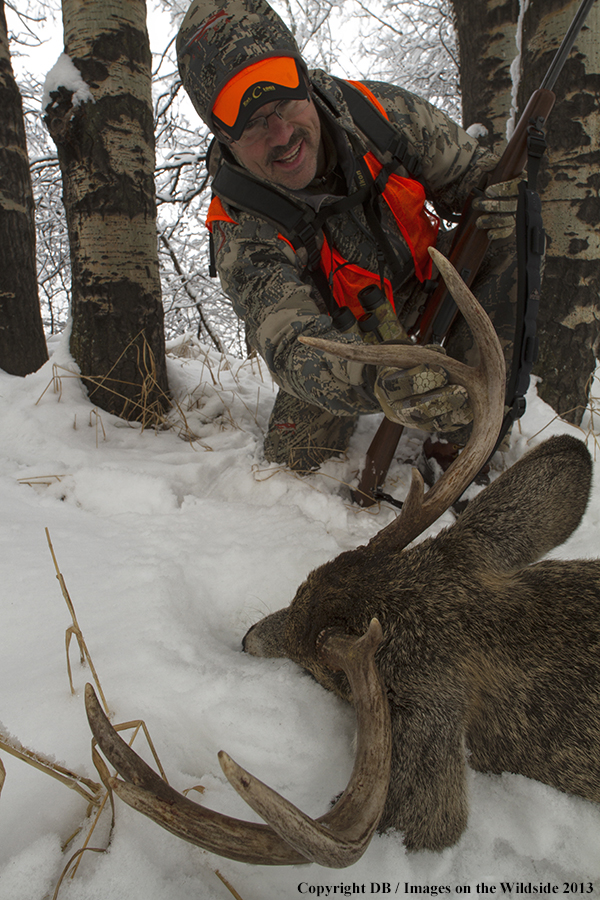 Hunter with bagged white-tailed deer.