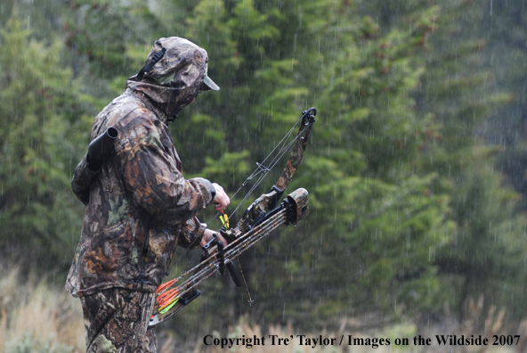 Bowhunter getting ready to draw back bow