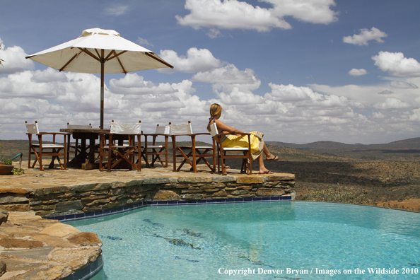 Woman by infinity pool