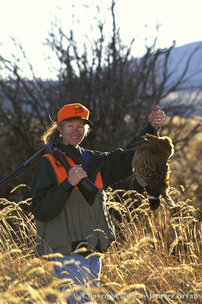 Upland game bird hunter with bagged pheasant.