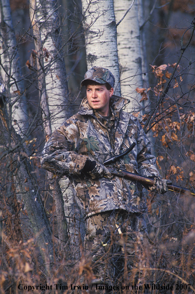 Bowhunter in forest.