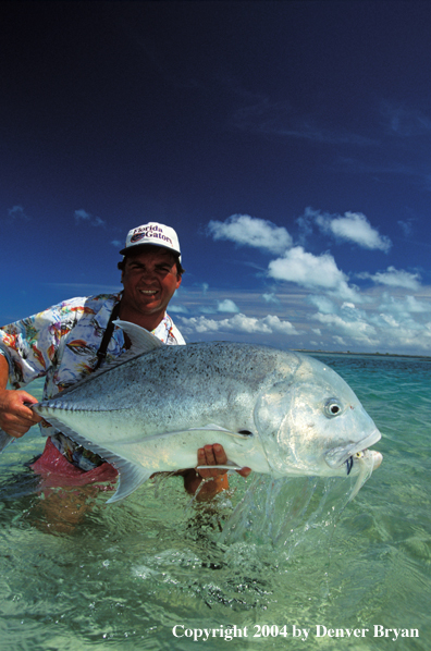 Saltwater flyfisherman holding trevally.