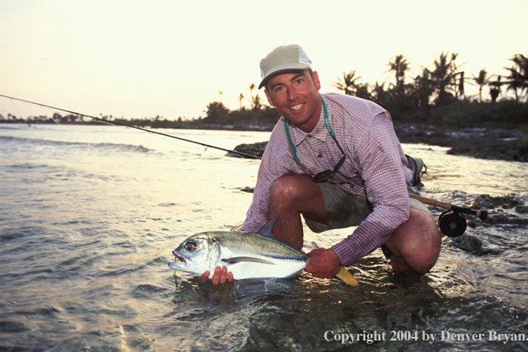 Saltwater flyfisherman releasing horse-eyed jack.