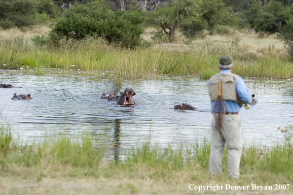 Flyfisherman in Africa with hippos in background.