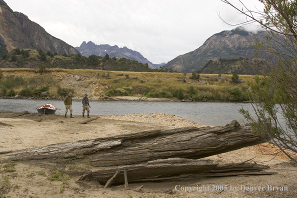 Flyfishermen walking up river.