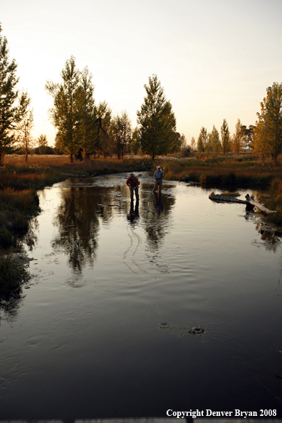 Flyfishermen fishing on warm spring