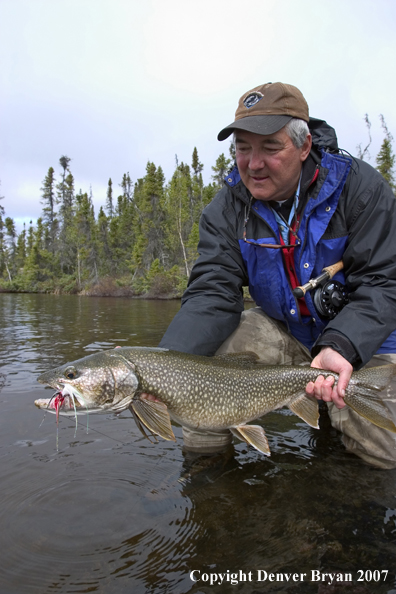 Flyfisherman with lake trout (MR).