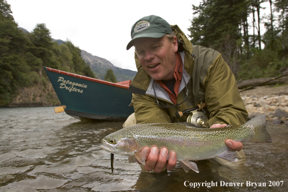 Flyfisherman holding nice rainbow trout.