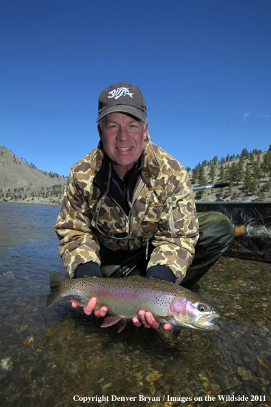 Flyfisherman with nice rainbow trout.