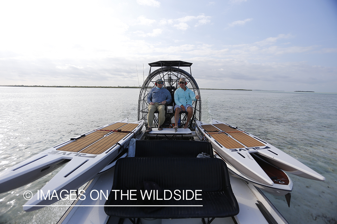 Flyfishermen on airboat with stand up paddle boards.