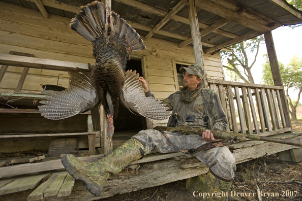 Turkey hunter in field with bagged bird