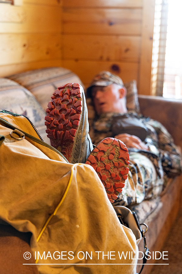 Turkey hunter asleep in cabin.