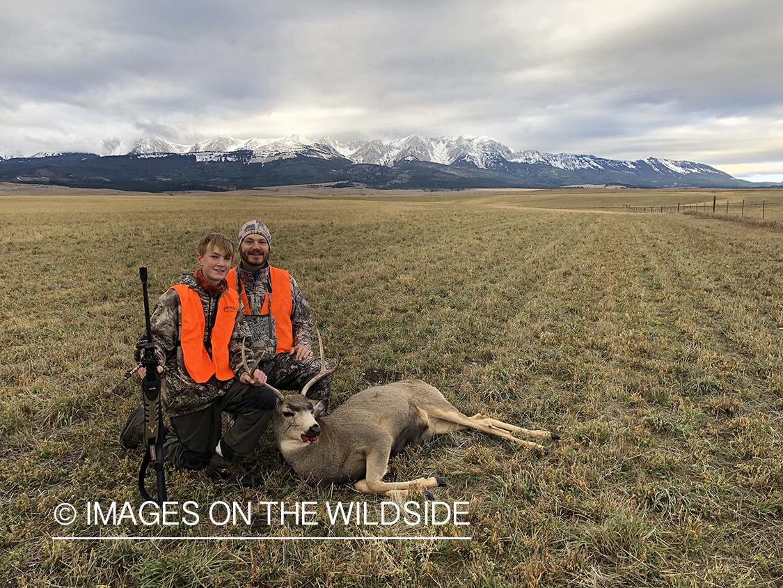 Father and son with downed mule deer.