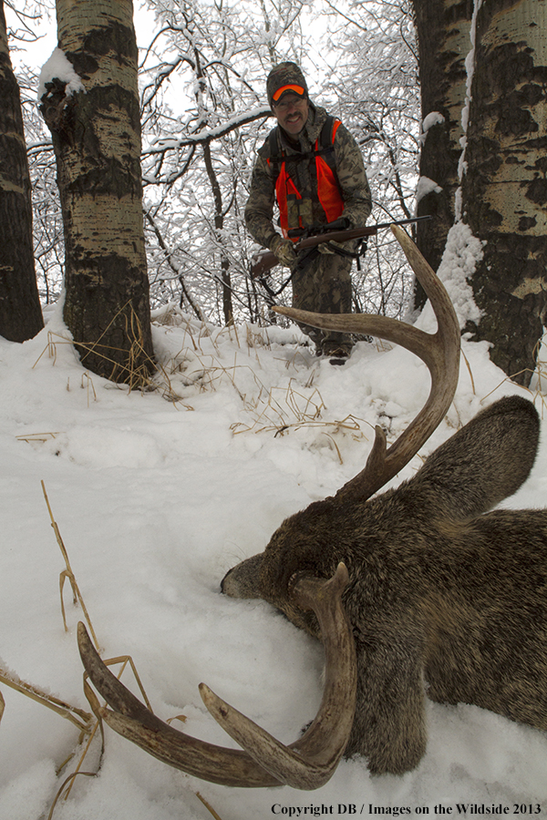 Hunter with bagged white-tailed deer.