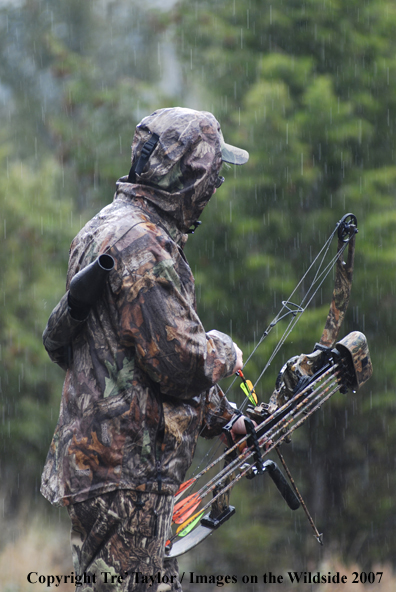 Bowhunter getting ready to draw back bow