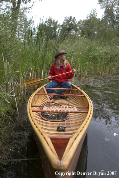 Woman canoeing on pond (MR).