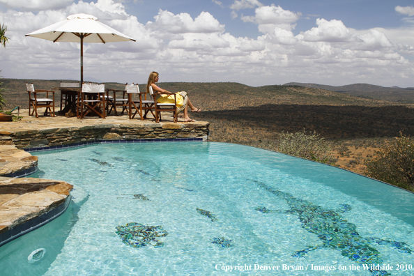 Woman by infinity pool