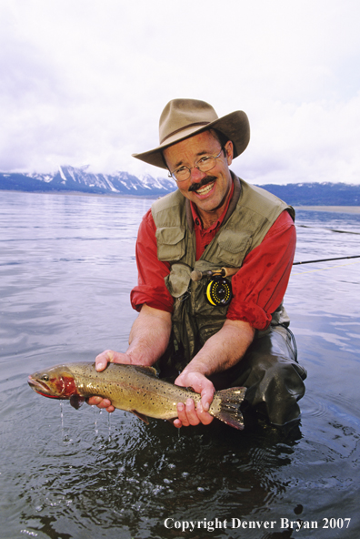 Flyfisherman with large cutthroat trout.