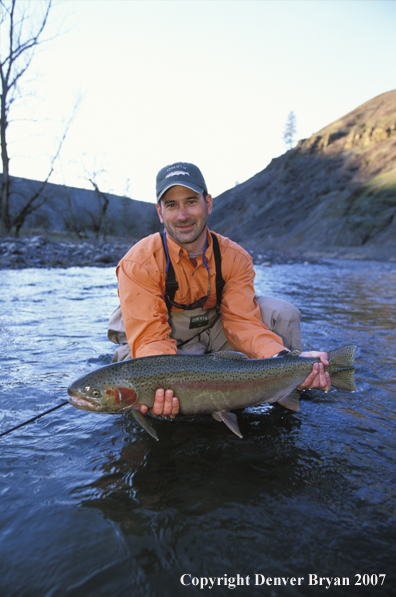 Flyfisherman holding steelhead.