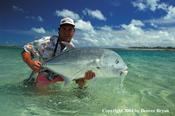 Saltwater flyfisherman holding trevally.